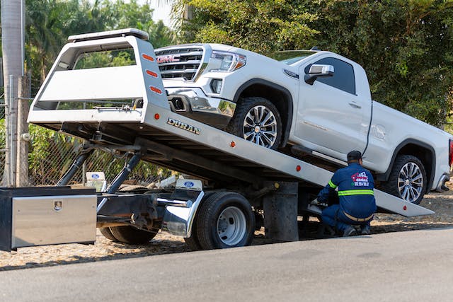 damaged car on tow truck