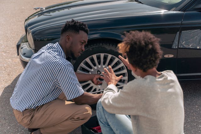 two people looking at car