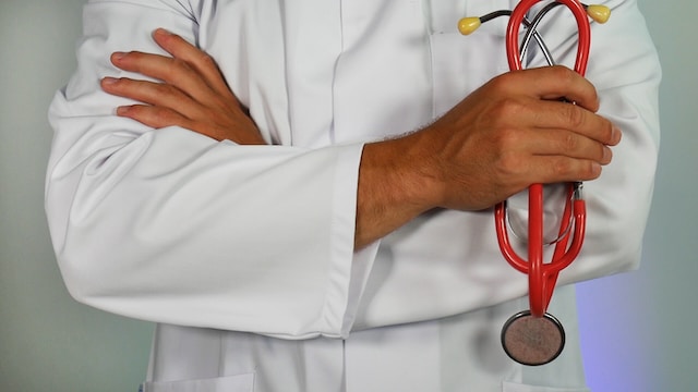 doctor crossing arms holding stethoscope