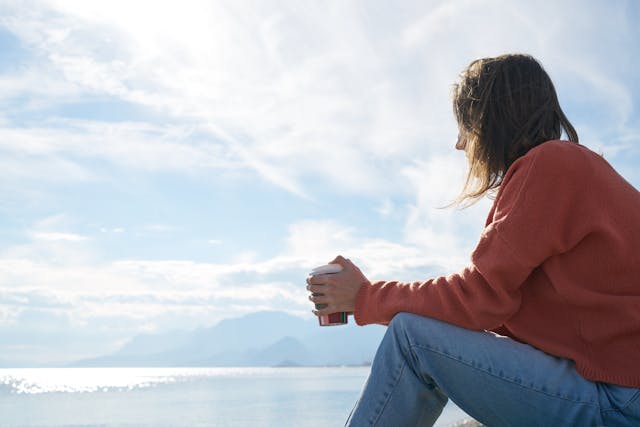 sad woman contemplating by ocean