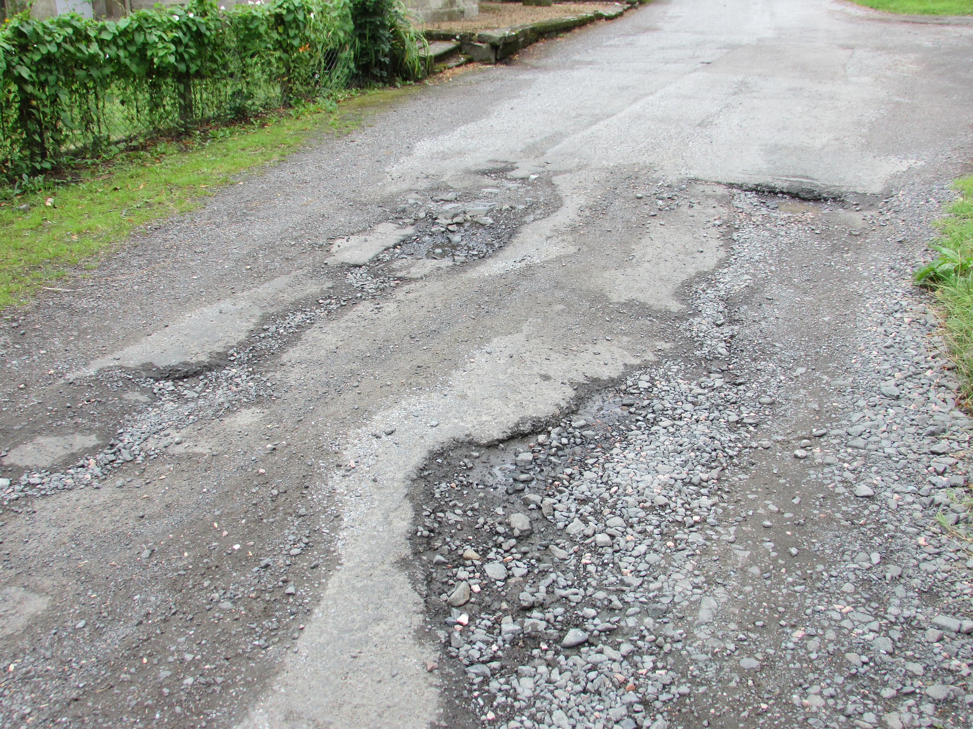 road littered with potholes